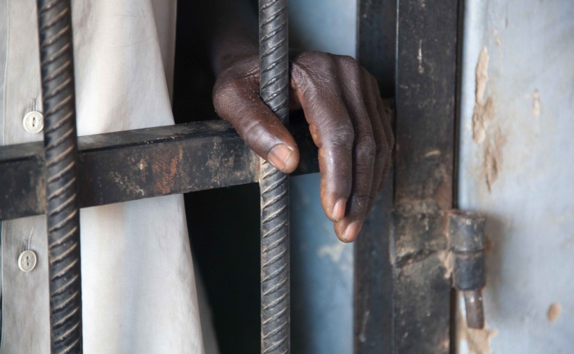 An inmate rests his hand on the bars of a prison controlled by the SLA/Mini Minawi in Shangle Tubaya village in north Darfur October 18, 2010. According to the U.N, the prison currently houses four inmates, who share a cell and are given food twice daily. Of the four, some have been jailed for several weeks without having a trial or legal representatives. Picture taken October 18, 2010. REUTERS/UNAMID/Albert Gonzalez Farran/Handout  (SUDAN - Tags: POLITICS CRIME LAW IMAGES OF THE DAY) FOR EDITORIAL USE ONLY. NOT FOR SALE FOR MARKETING OR ADVERTISING CAMPAIGNS. THIS IMAGE HAS BEEN SUPPLIED BY A THIRD PARTY. IT IS DISTRIBUTED, EXACTLY AS RECEIVED BY REUTERS, AS A SERVICE TO CLIENTS - RTXTM0I