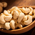 Cashews in hand made wooden spoon