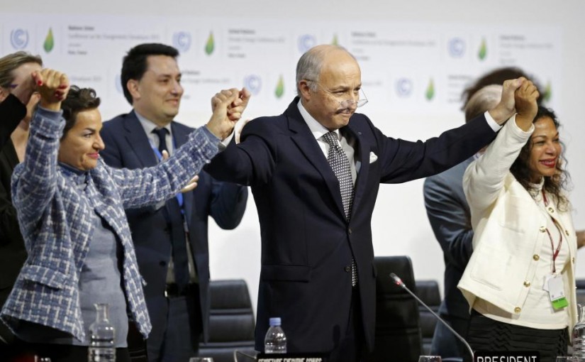 French Foreign Affairs Minister Laurent Fabius (C), President-designate of COP21 and Christiana Figueres (L), Executive Secretary of the UN Framework Convention on Climate Change, hold hands as they react during the final plenary session at the World Climate Change Conference 2015 (COP21) at Le Bourget, near Paris, France, December 12, 2015.     REUTERS/Stephane Mahe