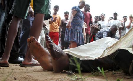 Residents look at the slain bodies of people killed at the Cibitoke district in Burundi's capital Bujumbura, December 9, 2015. REUTERS/Jean Pierre Aime Harerimana