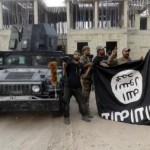Iraqi security forces hold an Islamist State flag which they pulled down at the University of Anbar, in Anbar province July 26, 2015.    REUTERS/Stringer