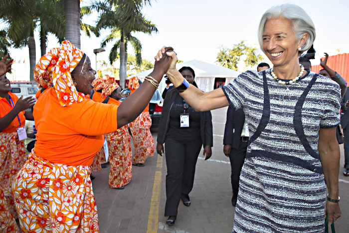 This handout photo released by the International Monetary Fund (IMF) shows IMF Managing Director Christine Lagarde (R) being greeted by local singers as she attends the opening session of the Africa Rising Conference, on May 29, 2014 at the Chissano Conference Center in Maputo.  Lagarde attends on May 29 a two-day major conference in Maputo that will bring together policymakers from across the region. AFP PHOTO / IMF / STEPHEN JAFFE 
-- RESTRICTED TO EDITORIAL USE - MANDATORY CREDIT " AFP PHOTO / IMF / STEPHEN JAFFE " - NO MARKETING NO ADVERTISING CAMPAIGNS - DISTRIBUTED AS A SERVICE TO CLIENTS --
