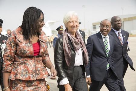 International Monetary Fund Managing (IMF) Director Christine Lagarde (C) is escorted by Nigeria's Finance Minister Kemi Adeosun (L) and Nigeria's Central Bank Governor Godwin Emefiele (2nd R) upon arriving at the Nnamdi Azikiwe International Airport in Abuja, Nigeria, January 4, 2016. REUTERS/IMF Staff Photo/Stephen Jaffe/HandoutA