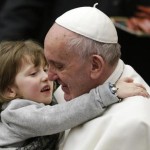 Pope Francis holds a child as he leads the weekly audience in Paul VI's hall at the Vatican January 20, 2016. REUTERS/Max Rossi