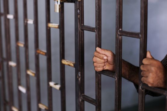 In this Friday, Aug. 24, 2012 photo, a Syrian prisoner holds the bars of a makeshift prison run by rebels in a former elementary school in Al-Bab on the outskirts of Aleppo, Syria. Many improvised detention centers have sprung up as rebels wrest cities from army control, but these facilities fall under no national or regional authority, causing concern among rights groups. (AP Photo/Muhammed Muheisen)