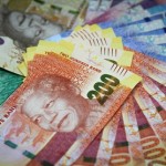 Mixed denomination rand currency banknotes are arranged for a photograph at a First National Bank (FNB) branch in Johannesburg, South Africa, on Friday, March 15, 2013. A recovery in mining and manufacturing is giving South Africa's rand and bonds a breather amid concern that growth is slowing while inflation accelerates. Photographer: Nadine Hutton/Bloomberg via Getty Images