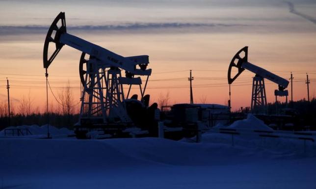 Pump jacks are seen at the Lukoil company owned Imilorskoye oil field, as the sun sets, outside the West Siberian city of Kogalym, Russia, January 25, 2016. REUTERS/Sergei Karpukhin