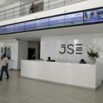 People walk near the reception at the Johannesburg Stock Exchange (JSE) in Sandton, Johannesburg, South Africa December 10, 2015.   REUTERS/Siphiwe Sibeko