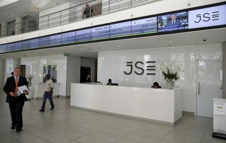 People walk near the reception at the Johannesburg Stock Exchange (JSE) in Sandton, Johannesburg, South Africa December 10, 2015.   REUTERS/Siphiwe Sibeko