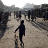 A Karamojong tribe boy plays with a toy decorated with election posters in town of Kaabong in Karamoja region, Uganda February 17, 2016. REUTERS/Goran Tomasevic