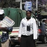 Hawkers sell newspapers and bottled water  on the streets of Zimbabwe's capital Harare, September 17, 2015.  REUTERS/Philimon Bulawayo