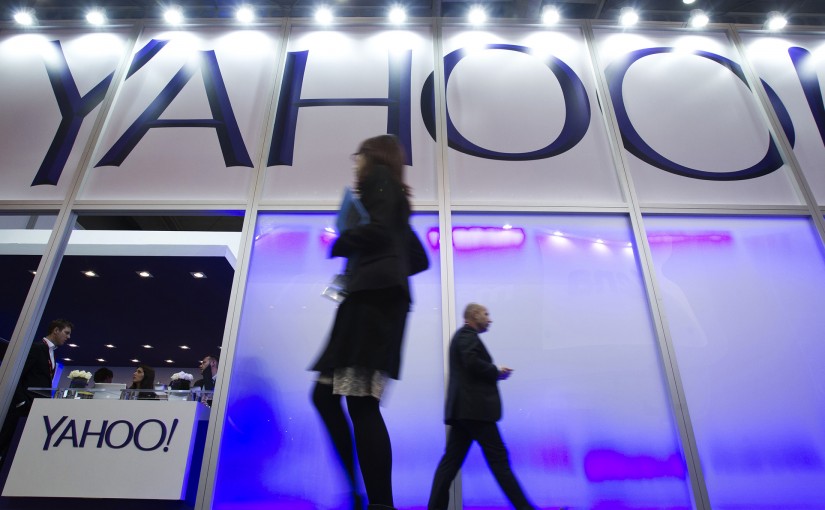 Pedestrians pass the Yahoo Inc. pavilion on day two of the Mobile World Congress in Barcelona, Spain, on Tuesday, Feb. 25, 2014. Top telecommunication managers will rub shoulders in Barcelona this week at the Mobile World Congress, Monday, Feb. 24 - 27, a traditional venue for showcasing the latest products for dealmaking. Photographer: Angel Navarrete/Bloomberg