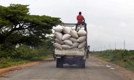 A man rides atop a truck ferrying bags of maize to a market along a road in the outskirts of Burundi's capital Bujumbura, April 30, 2015. REUTERS/Thomas Mukoya