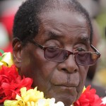 President Robert Mugabe is seen during celebrations to mark his 91st birthday in the resort town of Victoria Falls, Zimbabwe, Saturday Feb, 28, 2015. Mugabe turned 91 on the 21st of February and become the world's oldest leader, with his supporters saying they will back him to run his full term until 2018 - despite questions about his health and an economy that is crumbling under his watch. (AP Photo/Tsvangirayi Mukwazhi)