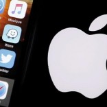 An Apple iPhone is pictured next to the logo of Apple in Bordeaux, southwestern France, February 26, 2016. REUTERS/Regis Duvignau