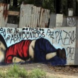 A person walks past a graffiti depicting the drowned Syrian toddler Aylan Kurdi in Sorocaba, Brazil, September 5, 2015. REUTERS/Paulo Whitaker/Files