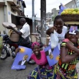 Street vendors hold campaign posters for presidential candidate Patrice Talon ahead of the second round of Benin's presidential election on Sunday in Cotonou, Benin, March 18, 2016. REUTERS/Charles Placide Tossou