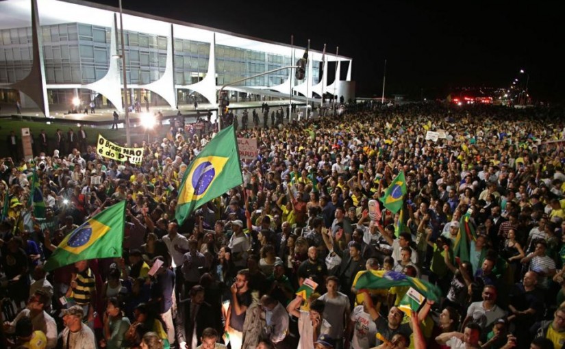Demonstrators call for the impeachment of Brazil's President Dilma Rousseff and protest the naming of her mentor, former President Luiz Inacio Lula da Silva, as her new chief of staff, outside Planalto presidential palace in Brasilia, Brazil, Wednesday, March 16, 2016. Supporters say the move will help the president fight impeachment proceedings and critics blast it as a scheme to shield Lula from possible detention in corruption probes. (AP Photo/Eraldo Peres)