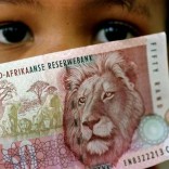 A South African child holds a 50 rand note  in a file photo.