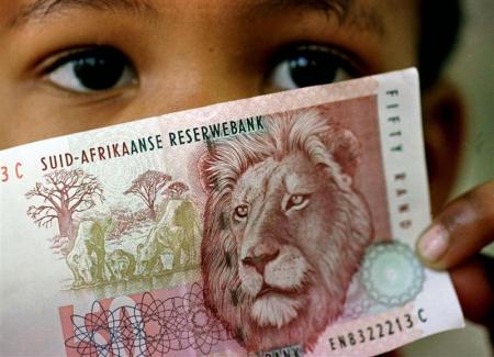 A South African child holds a 50 rand note  in a file photo.