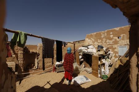 An indigenous Sahrawi woman stands inside her shelter, which was damaged by flood last October, in a refugee camp of Boudjdour in Tindouf, southern Algeria March 3, 2016. REUTERS/Zohra Bensemra