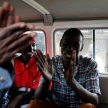 Ralson Saisi Wasike, father to Dealeryn Saisi Wasike, a baby girl rescued from the rubble of a six-storey building that collapsed after days of heavy rain, sings in joy inside a Kenya Red Cross van after addressing a news conference in Nairobi, Kenya May 3, 2016. REUTERS/Thomas Mukoya - RTX2CM1P