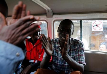 Ralson Saisi Wasike, father to Dealeryn Saisi Wasike, a baby girl rescued from the rubble of a six-storey building that collapsed after days of heavy rain, sings in joy inside a Kenya Red Cross van after addressing a news conference in Nairobi, Kenya May 3, 2016. REUTERS/Thomas Mukoya - RTX2CM1P