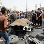 People gather at the scene of a car bomb attack in Baghdad's mainly Shi'ite district of Sadr City, Iraq, May 11, 2016. REUTERS/Wissm al-Okili