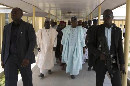 Governor of Borno state Kashim Shettima (C) leaves a hospital that is currently under construction in Maiduguri May 22, 2014.  REUTERS/Joe Penney