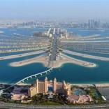 An aerial view of Atlantis hotel is seen with The Palm Jumeirah in Dubai in this December 21, 2009 file photo. The revolts that began in Tunisia at the end of 2010 and spread across the Middle East and North Africa had a devastating impact on tourism, but not everyone in the region lost out. While recovery from the turmoil has been at best tentative, at worst non existent, places where the Arab Spring has not reached have been unexpected beneficiaries. REUTERS/Matthias Seifert/Files