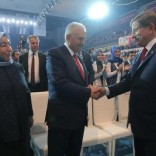 Transportation Minister Binali Yildirim (C), accompanied by his wife Semiha Yildirim (L), shakes hands with Turkey's outgoing Prime Minister Ahmet Davutoglu during the Extraordinary Congress of the ruling AK Party (AKP) to choose the new leader of the party, in Ankara, Turkey May 22, 2016. REUTERS/Riza Ozel/Pool
