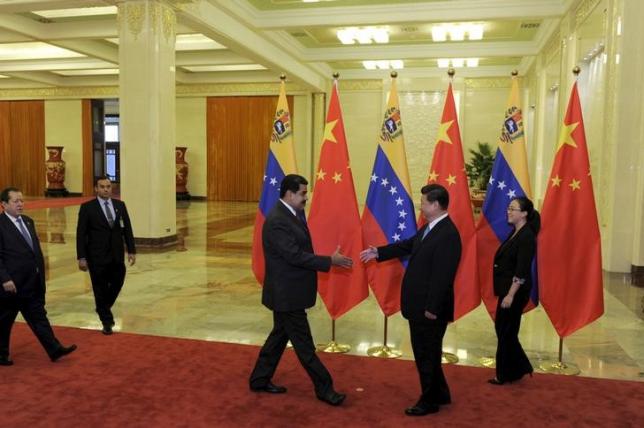 File photo of Chinese President Xi Jinping preparing to shake hands with Venezuelan President Nicolas Maduro before their meeting at the Great Hall of the People in Beijing, China, September 1, 2015. REUTERS/Parker Song/Pool