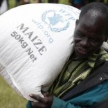 A Malawian man carries food aid distributed by the United Nations World Food Progamme (WFP) in Mzumazi village near the capital Lilongwe, February 3, 2016.  REUTERS/Mike Hutchings