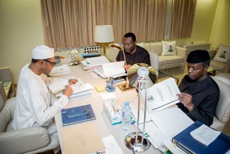President Muhammadu Buhari, Vice President Yemi Osinbajo and Minister of Budget and National Planning Senator Udoma Udo Udoma read copies of the details of the submitted 2016 national budget by the National Assembly in Abuja, Nigeria April 10, 2016 REUTERS/Stringer