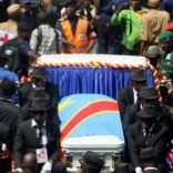 A general view taken through a window shows mourners escorting the casket of legendary Congolese singer Papa Wemba, born Jules Shungu Wembadio Pene Kikumba, from the the Notre Dame du Congo Cathedral for burial, along the streets of the Democratic Republic of Congo's capital Kinshasa, May 4, 2016. REUTERS/Jean Robert