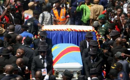 A general view taken through a window shows mourners escorting the casket of legendary Congolese singer Papa Wemba, born Jules Shungu Wembadio Pene Kikumba, from the the Notre Dame du Congo Cathedral for burial, along the streets of the Democratic Republic of Congo's capital Kinshasa, May 4, 2016. REUTERS/Jean Robert