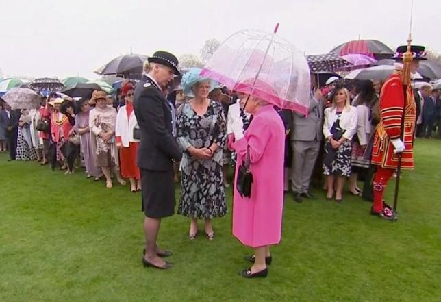 Britain's Queen Elizabeth speaks to Commander Lucy D'Orsi during a garden party at Buckingham Palace in London, in this still image taken from video, Britain, May 10, 2016. REUTERS/ROYAL POOL via Reuters TV