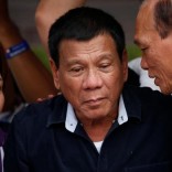 Presidential candidate Rodrigo "Digong" Duterte (C) listens as Senatorial candidates Dionisio Santiago (R) and Sandra Cam talk to him during election campaigning in Malabon, Metro Manila in the Philippines April 27, 2016.    REUTERS/Erik De Castro