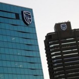 The logo of South Africa's Standard Bank is seen above the company's headquarters in Cape Town, South Africa May 6, 2016. REUTERS/Mike Hutchings/File Photo