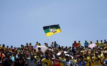Supporters of the African National Congress (ANC) wave a party flag during the party's 104th anniversary celebrations in Rustenburg, South Africa January 9, 2016. REUTERS/Siphiwe Sibeko