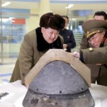 North Korean leader Kim Jong Un looks at a rocket warhead tip after a simulated test of atmospheric re-entry of a ballistic missile, at an unidentified location in this undated file photo released by North Korea's Korean Central News Agency (KCNA) in Pyongyang on March 15, 2016.     REUTERS/KCNA
