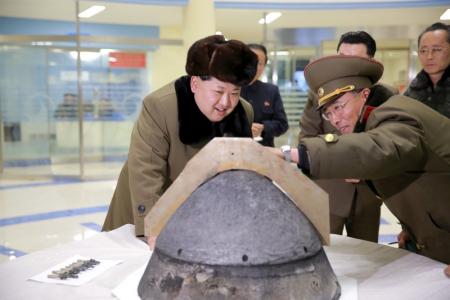 North Korean leader Kim Jong Un looks at a rocket warhead tip after a simulated test of atmospheric re-entry of a ballistic missile, at an unidentified location in this undated file photo released by North Korea's Korean Central News Agency (KCNA) in Pyongyang on March 15, 2016.     REUTERS/KCNA