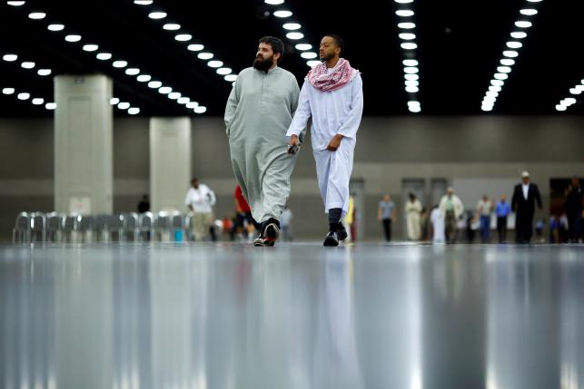 People attend the janazah prayer, an Islamic funeral for the late boxing champion Muhammad Ali in Louisville, Kentucky, U.S. June 9, 2016. REUTERS/Carlos Barria