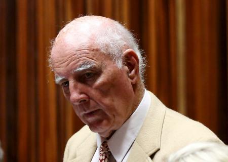 Former Grand Slam doubles champion Bob Hewitt looks on ahead of court proceedings at the  South Gauteng High Court in Johannesburg February 10, 2015.   REUTERS/Siphiwe Sibeko