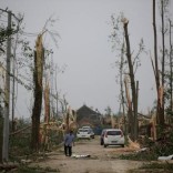 A villager walks on a damaged road after a tornado hit Funing on Thursday, in Yancheng, Jiangsu province, June 24, 2016. REUTERS/Aly Song