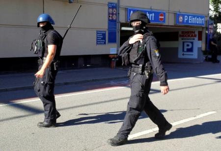 German special police walks past a cinema complex after a masked man with a gun and ammunition belt opened fire in the small western town of Viernheim, near Frankfurt, Germany, June 23, 2016.        REUTERS/Ralf Banser