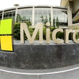 FILE - This July 3, 2014 file photo taken with a fisheye lens shows Microsoft Corp. signage outside the Microsoft Visitor Center in Redmond, Wash. Microsoft will acquire Stockholm-based game maker Mojang, the maker of the popular game Minecraft for $2.5 billion, the company announced Monday, Sept. 15, 2014. (AP Photo Ted S. Warren, File)