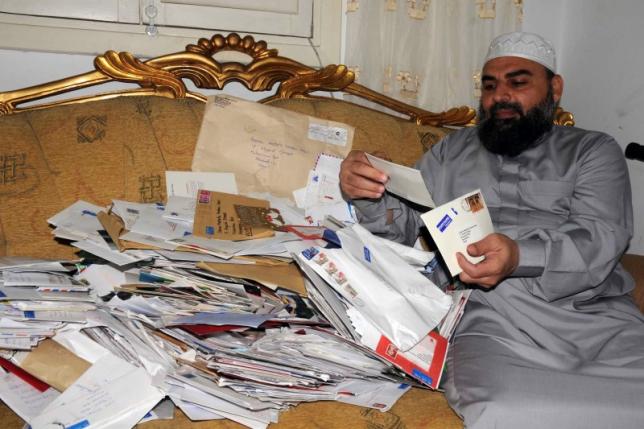 Egyptian cleric Hassan Mustafa Osama Nasr, also known as Abu Omar, shows letters of well wishes from his supporters from around the world during a Reuters interview in his house in Alexandria, Egypt May 13, 2008. REUTERS/Stringer
