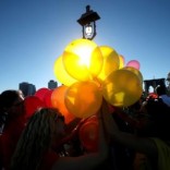 People hold balloons on the Brooklyn Bridge in New York, U.S., June 14, 2016, during a gathering to remember the victims of the mass shooting in Orlando. REUTERS/Mike Segar