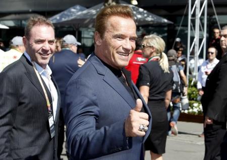 Actor Arnold Schwarzenegger reacts as he arrives at the Australian Formula One Grand Prix in Melbourne. REUTERS/Brandon Malone